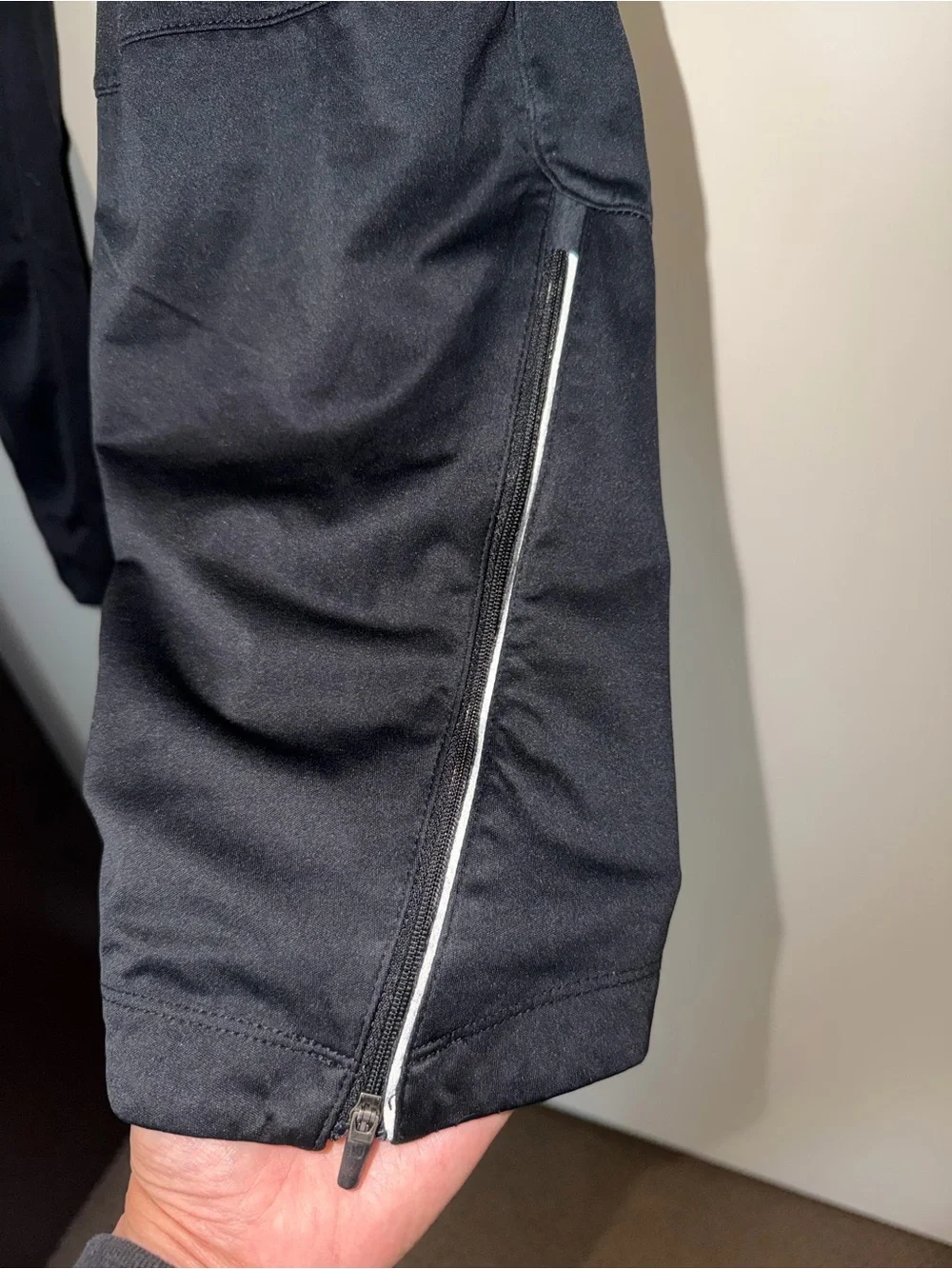 Nike Black Track Pants with White Swoosh and Reflective Details